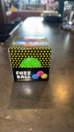 New green fuzzball squishy in its original box