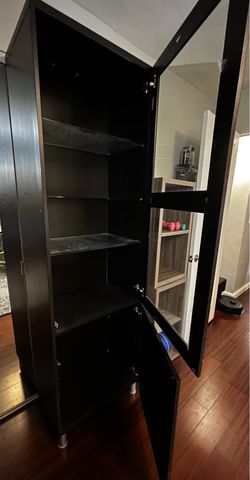 Two brown/black IKEA cabinets.  Glass door.