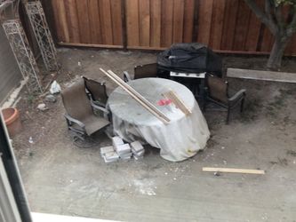 Stone table, 4 chairs and 2 rockers (seats 6)