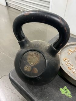 60 pound kettle bell and a set of 25 pound plates