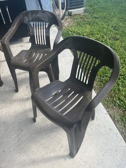 two plastic chairs for back yard