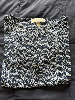 It’s A Beautiful Blouse From Michael Kors The Color Is White And Navy Blue. The Size Is Medium.