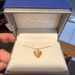 14k Yellow Gold & Diamond Heart Pendant Necklace,  featuring textured gold and two small diamonds. 18” Box Chain