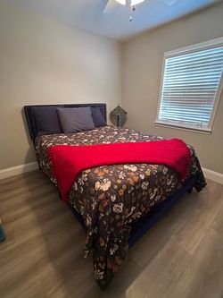 Queen Blue upholstered bed frame with tuffted buttons