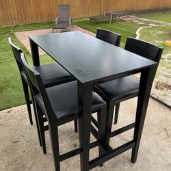 Black bar-height table with 4 matching chairs 