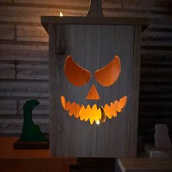 Wooden jack o lanterns! Lots of faces to pick from, comes with LED candle