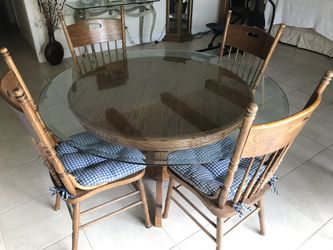 4 chair round oak dining room table with glass top.