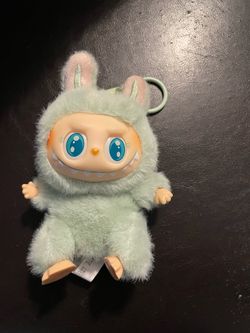 POP MART THE MONSTERS Have a Seat vinyl plush keychain in the Ququ colorway.