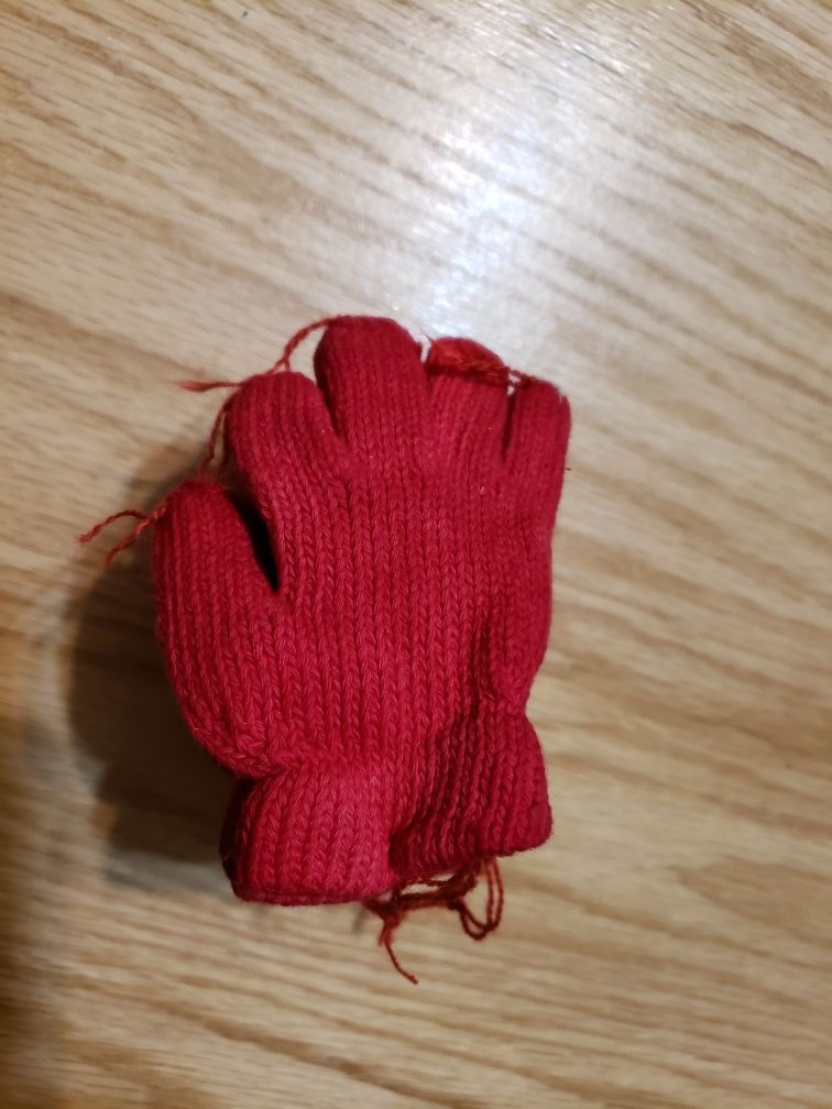 A dozen tiny red gloves