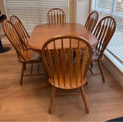 Oak dining set expands to seat 12