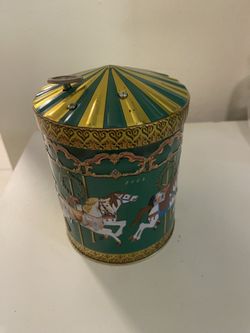 Vintage 2008 German cookie tin and its musical. Horse carousel details with green.
