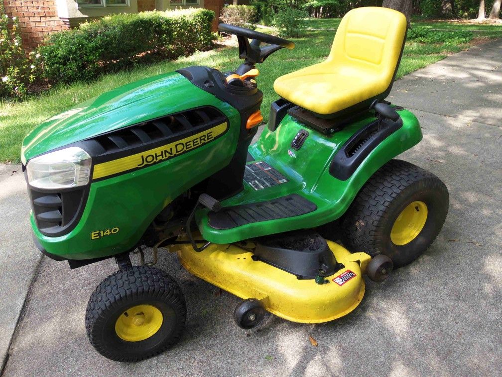 Almost new John Deere E140 riding mower only 28.1 hrs. 6yr warranty for