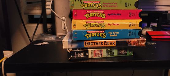 VHS tapes Teennage Mutant Ninja Turties and Brother Bear.