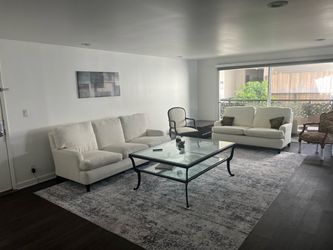 White Living room couch and loveseat with steel glass