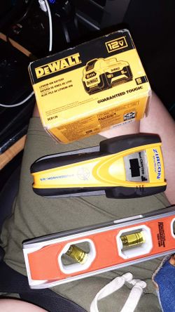 A dewalt battery a stud tester and a leveler
