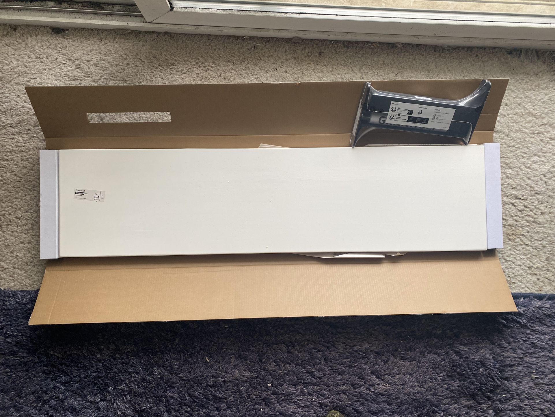 white IKEA Tranhult shelf with black mounting hardware