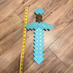 Minecraft Diamond Sword-Pixelated Toy Sword-Blue and brown pixelated toy sword, approximately 16 inches long.