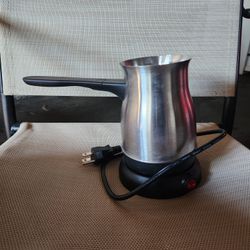  a stainless steel coffee pot on an electric base, ready for brewing. $5 pickup only 