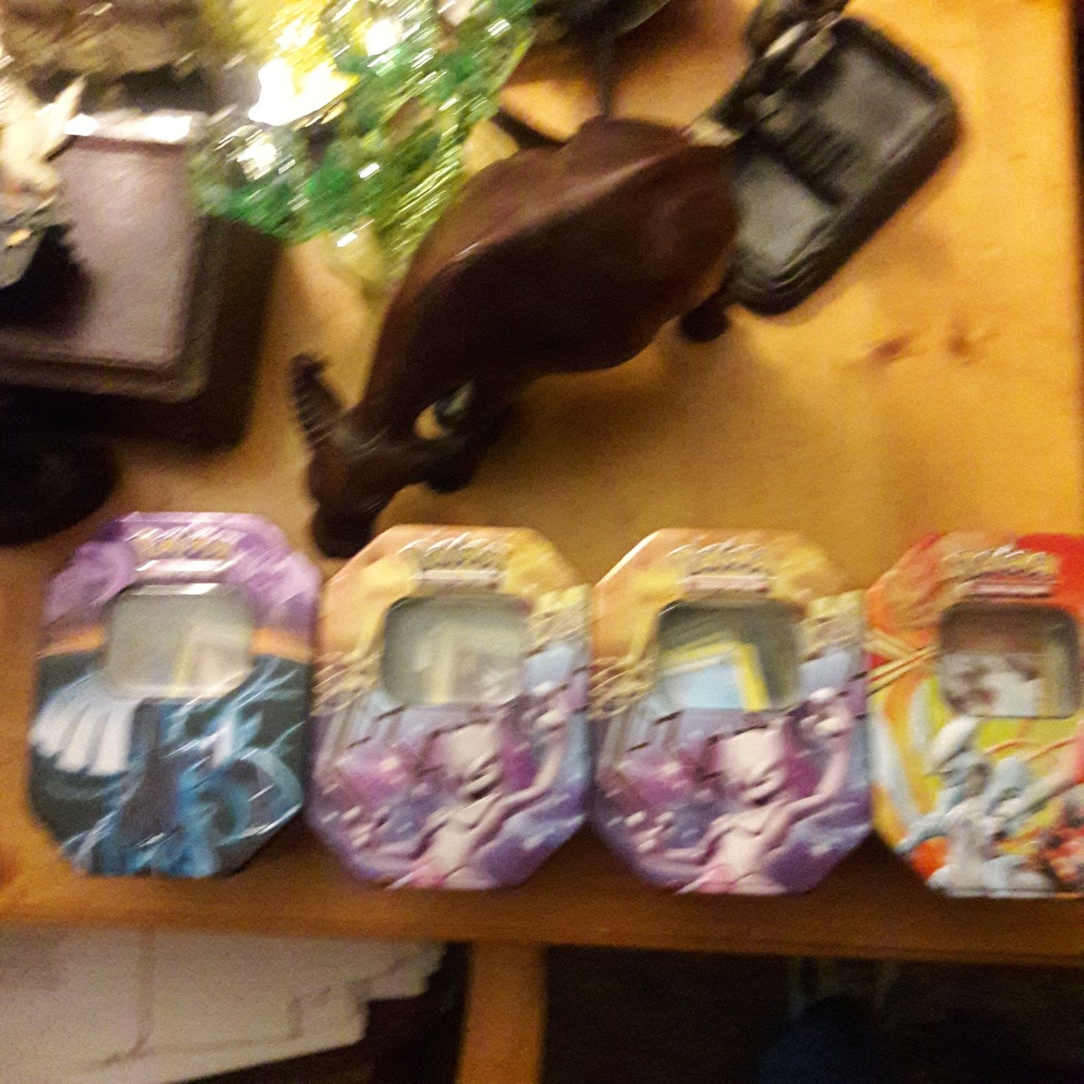 4 tins of Pokemon cards