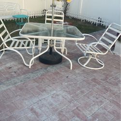 A Nice Outdoor Table With Three Chits