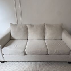 Beige three-seater sofa