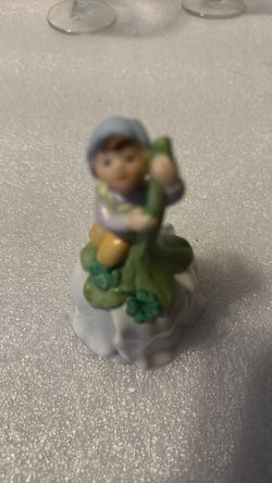 Bisque-style figurine atop glossy porcelain tulip bell base working clapper