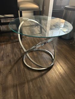 Round glass coffee table with chrome base