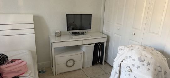White acrylic table and it comes with a chair.