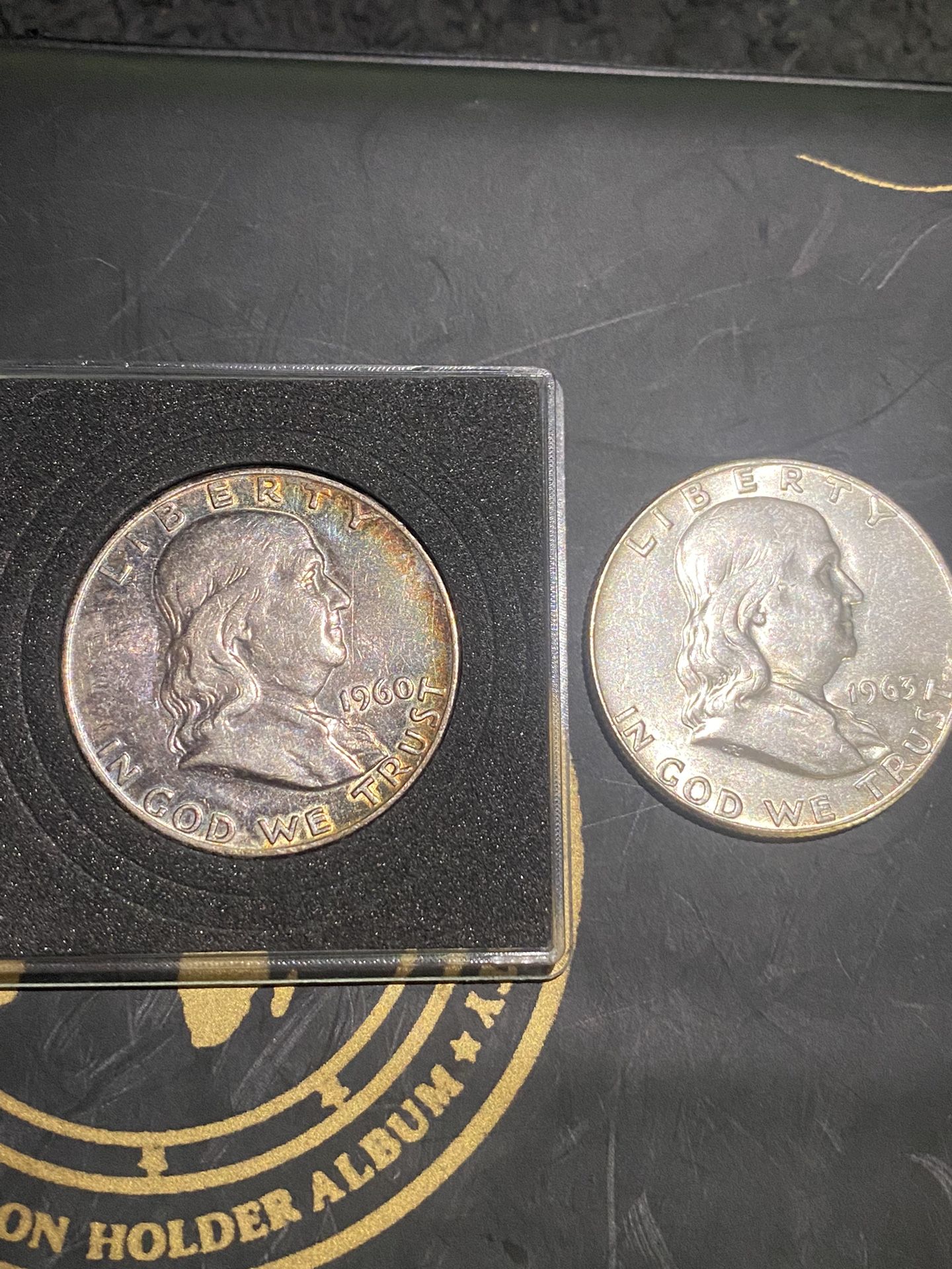 Two Benjamin Silver half dollars the rainbow toned one is 1960. The othes proof.