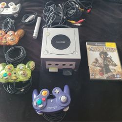 Nintendo gamecube w/ 4 controllers, a microphone, 2 memory cards, and game