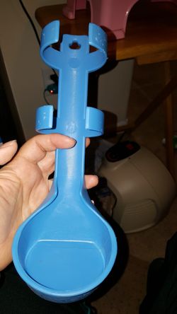 Dog traveling holds a water bottle