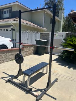 Squat/bench rack 2-35lb plates 1-45lb Olympic barbell 1-heavy duty flat bench
