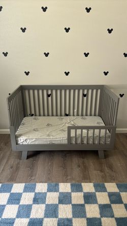 Gray toddler bed with mattress