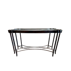 Dark mahogany MCM console table featuring eight faux bamboo legs, iron cross stretcher base, scalloped frame and beveled glass top.
