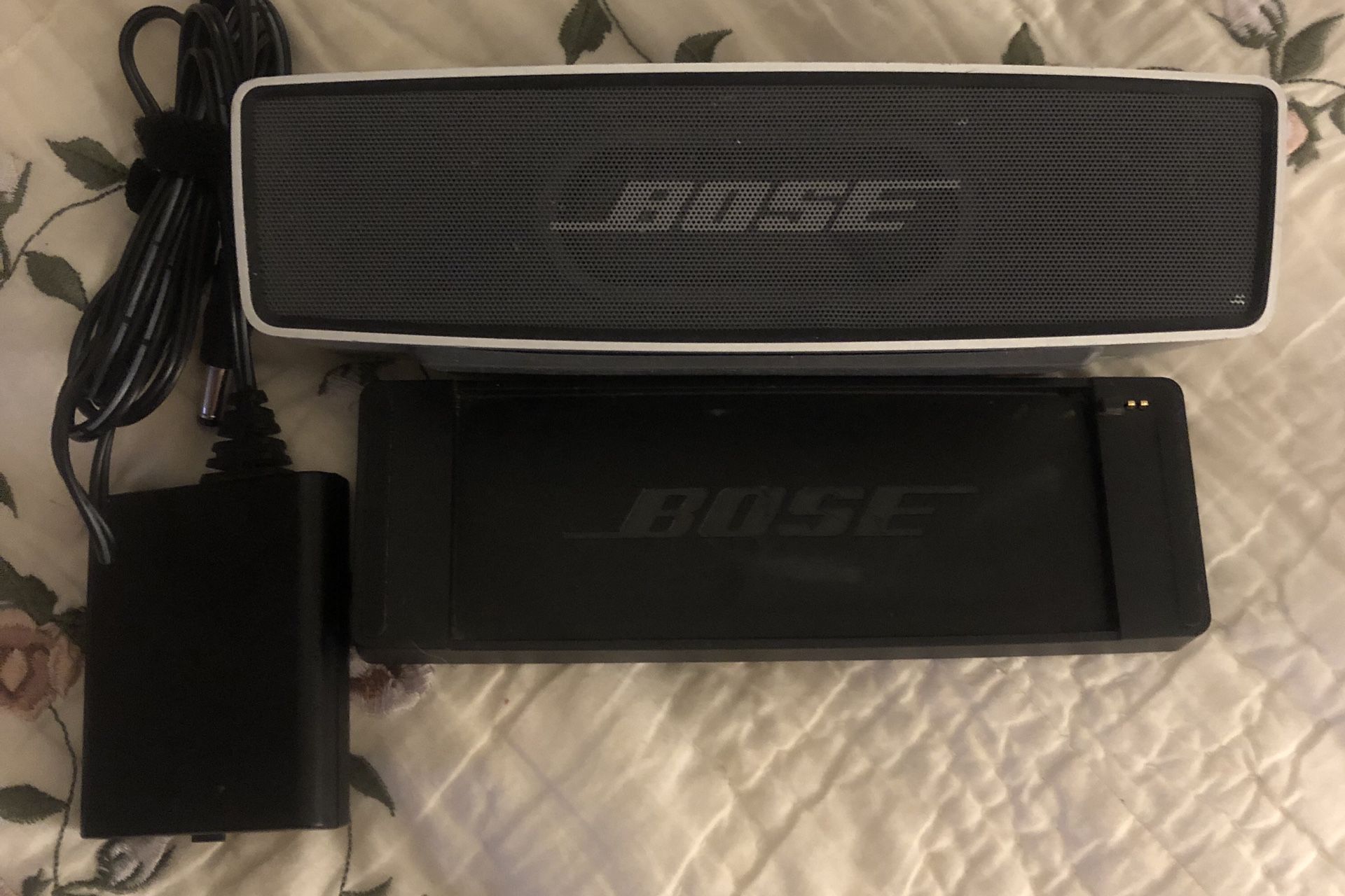 Bose Soundlink Mini Bluetooth Speaker, With Charging Cradle And Cord. Small Dent In Front Grill. Doesn’t Effect Sound At All. Awesome Sound. We can m