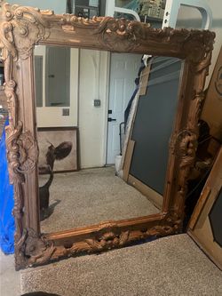 Mirror with hand carved wooden frame.