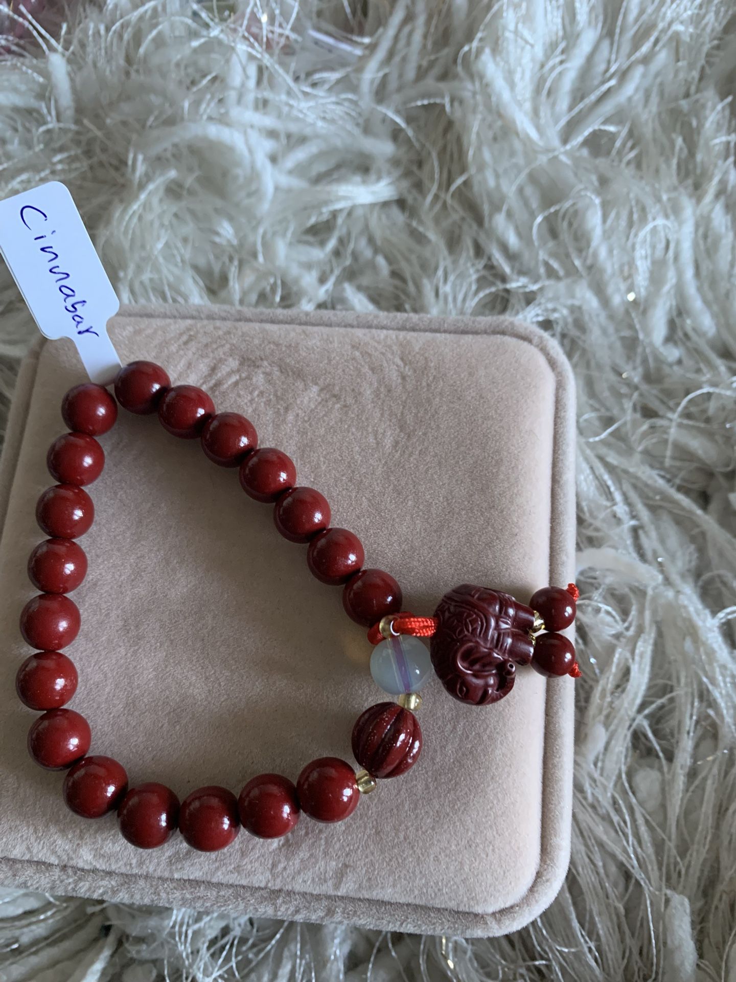 Red cinnabar bead bracelet with decorative elephant charm