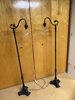 Set of two ornate antique heavyweight iron floor lamps