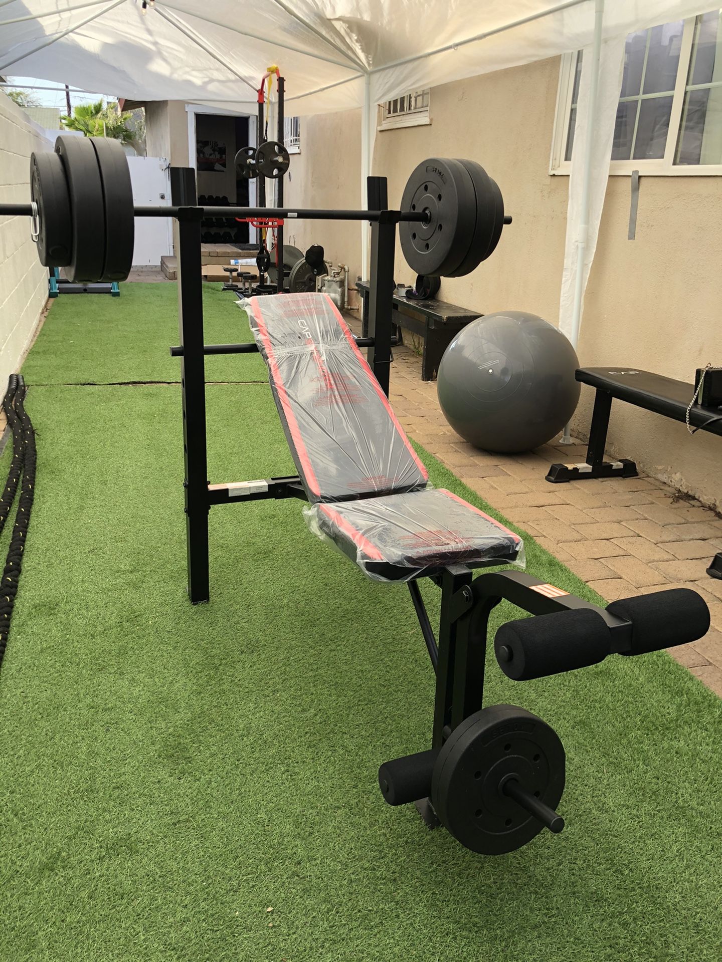 Gym Equipment Adjustable Bench press, barbell, leg developer and 100lbs of weight
