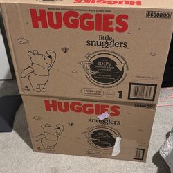 Two unopened boxes of size 1 diapers