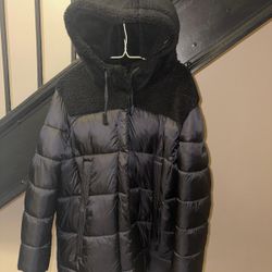 Koolaburra by UGG women's puffer jacket. It is often described as a "mixed-media" jacket because of the combination of the puffer material and a sherp