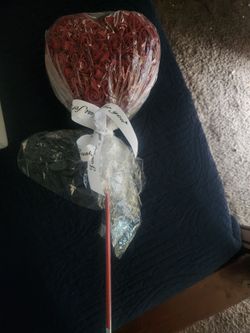decorative heart-shaped arrangement made of red artificial foam roses.