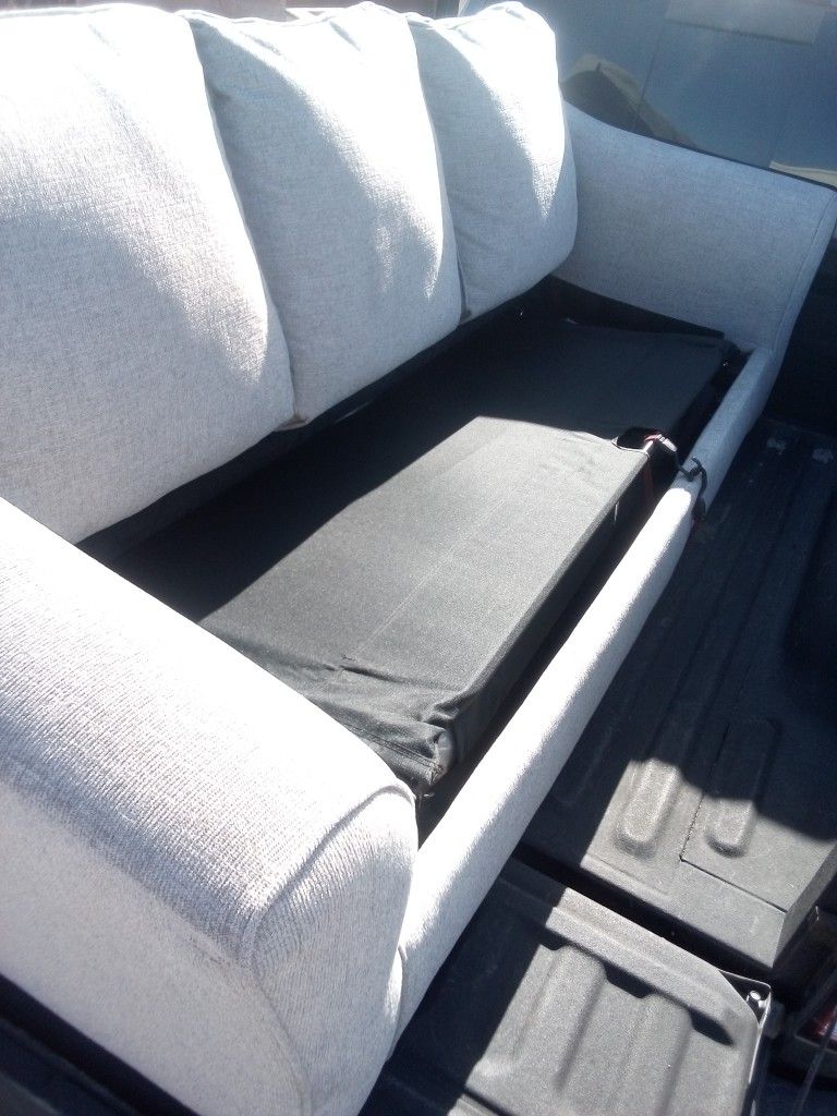 Comfortable beige sectional sofa with patterned cushions.