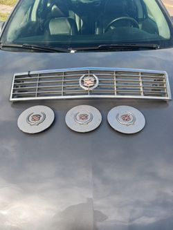 Cadillac Elante 3 Center Caps And A Grill
