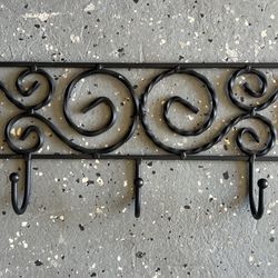 Forged coat rack, made of black metal.
