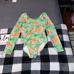Girls size large Art Class long-sleeve swimsuit featuring a bold floral design. It is designed with UPF 50+ sun protection must pick up 
