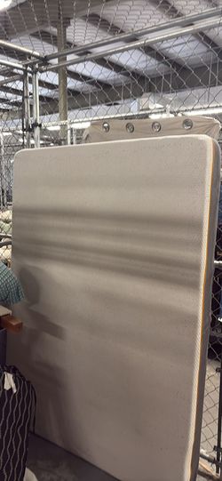 Queen size mattress and wooden headboard.