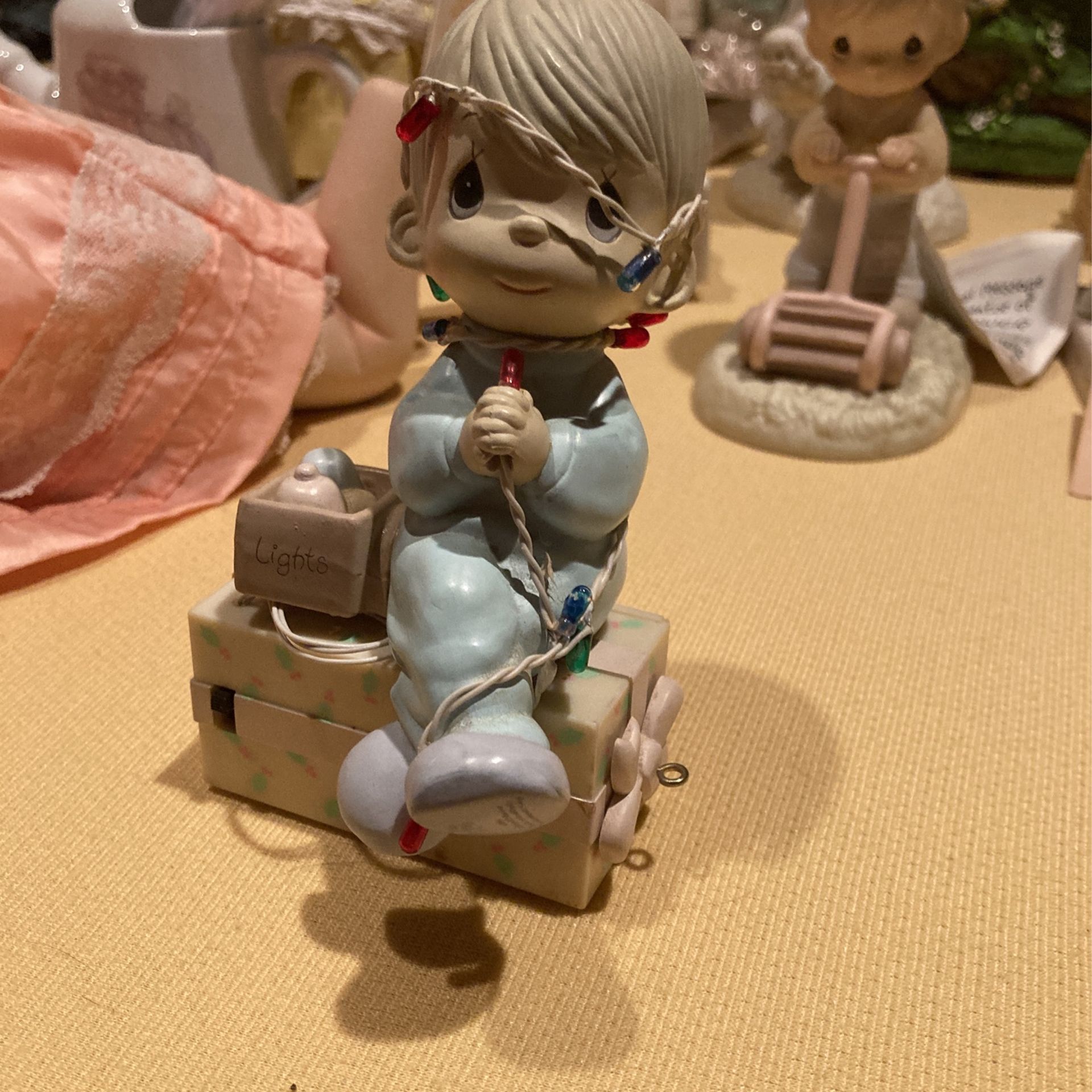 Vintage precious moments little boy tangled up in the Christmas lights sitting on a Christmas present