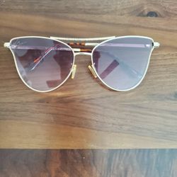 Vince Camuto cat-eye aviator sunglasses with a gold-tone metal frame and a gradient purple lens. 