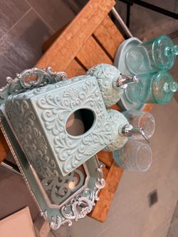 bathroom accessory set in a soft aqua/mint color